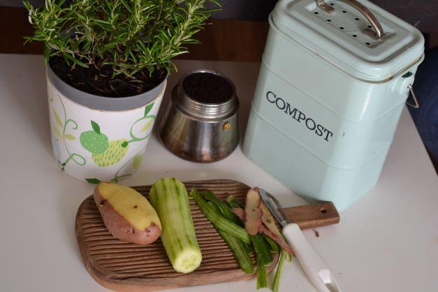 Compost container and food on cutting board