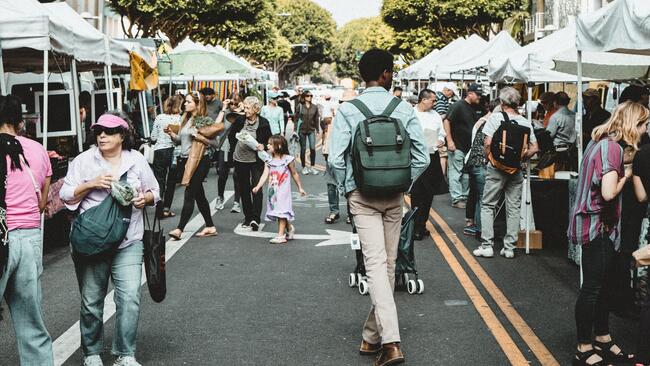 consumers walking among pop up tents