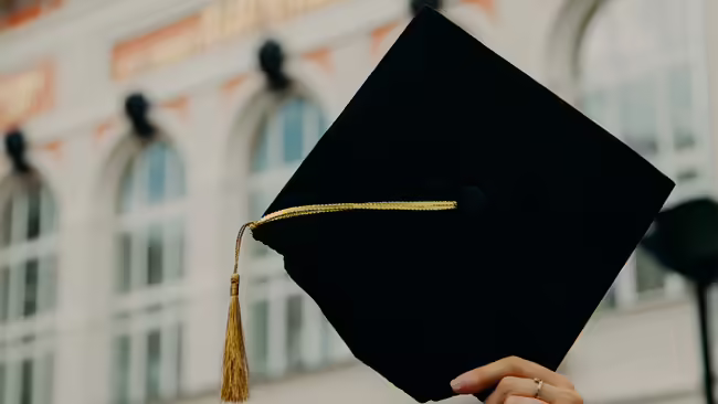 person holding black graduation cap