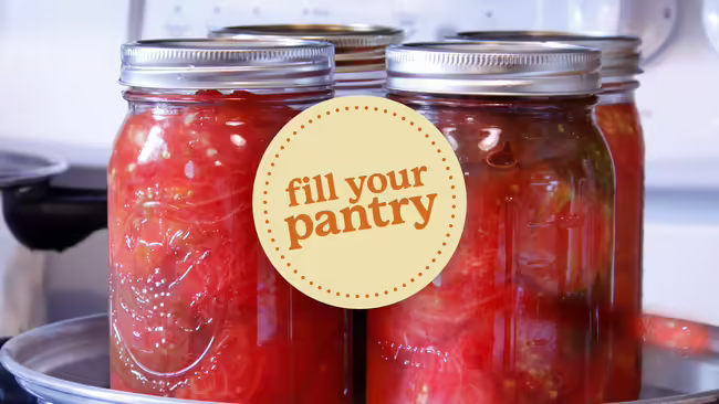 clear mason jars with strawberry preserves.