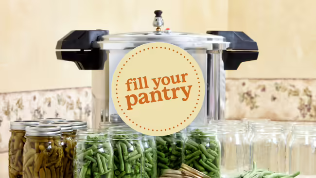 a pressure canner with mason jars full of vegetables