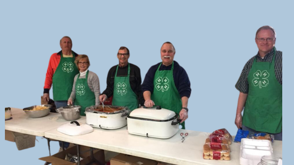 Members of the Foundation are ready to serve up a pork chop meal