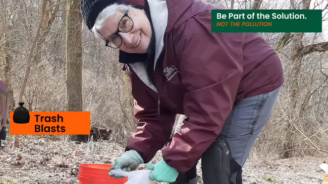 volunteer collecting trash from forest
