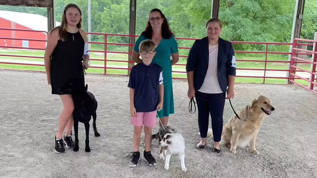 3 4-H members with their dogs and leader of the dog show club