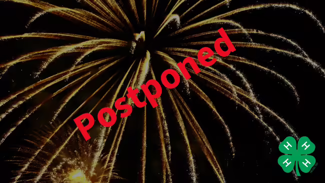 black background with firework with postponed on it