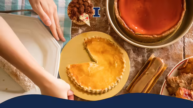 Baked goods and desserts sitting on a wooden table with hands placing a plate on the table.