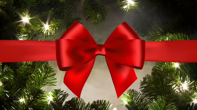 An evergreen wreath with lights and a red bow