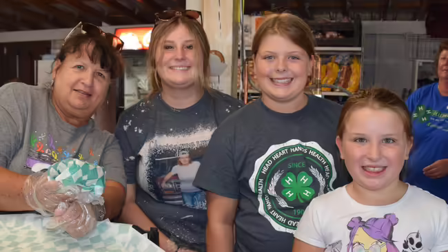 4-H club leader with three girls