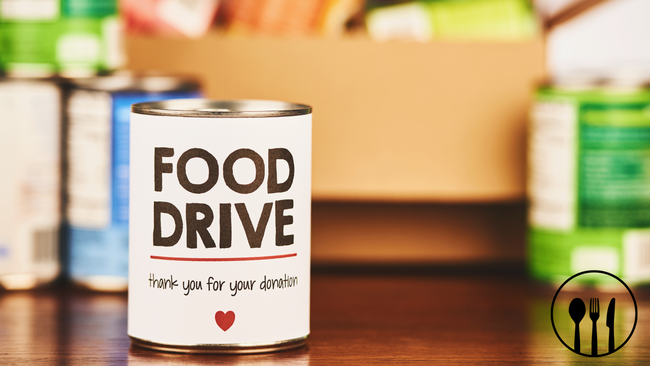 A canned food that read "food drive - thank you for your donation" when other canned foods in the background.