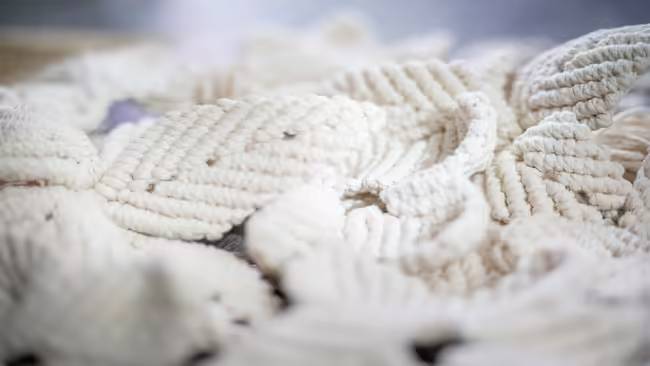 small macrame projects scattered on a table