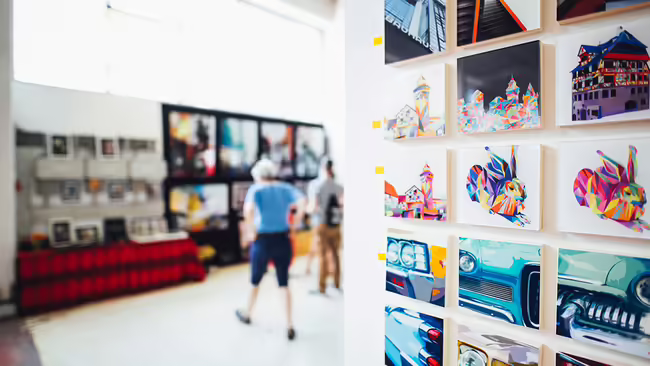 art gallery with people walking around looking at exhibits