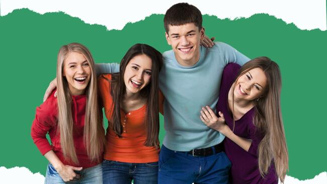 group of teens hugging and smiling at the camera