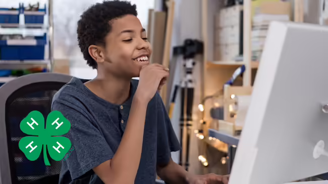 young teenager in from of a computer