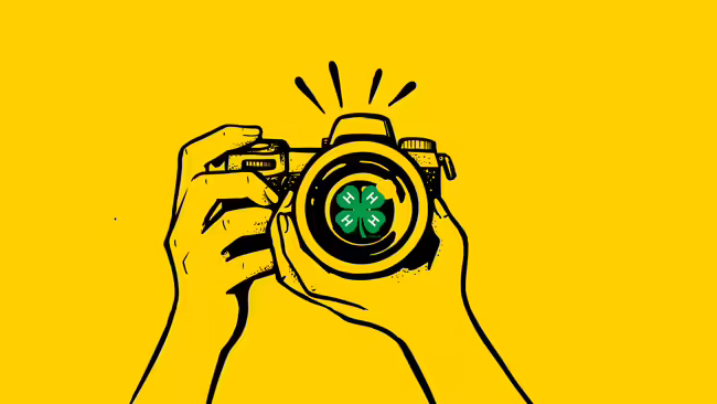 Graphic of a camera with a 4-H cloverleaf in the center.