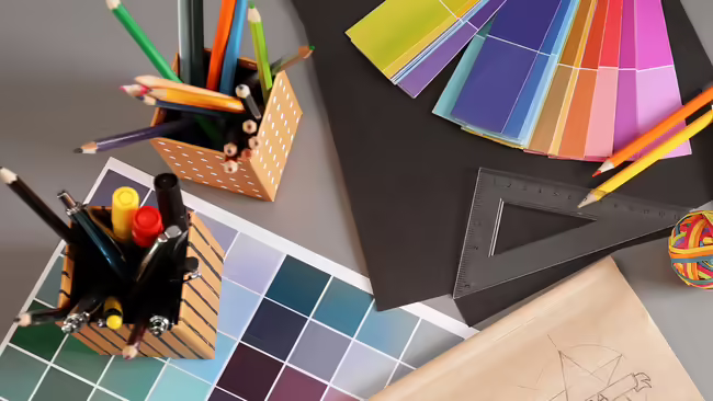 paint color samples and boxes of pencils