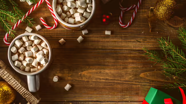 Hot chocolate and candy canes on a wood table