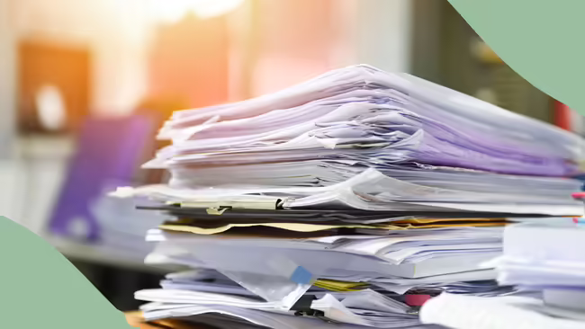 messy stack of papers on a desk