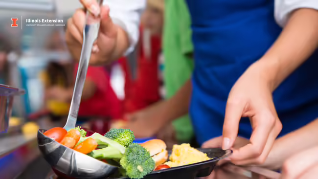 person serving vegetables on a tray