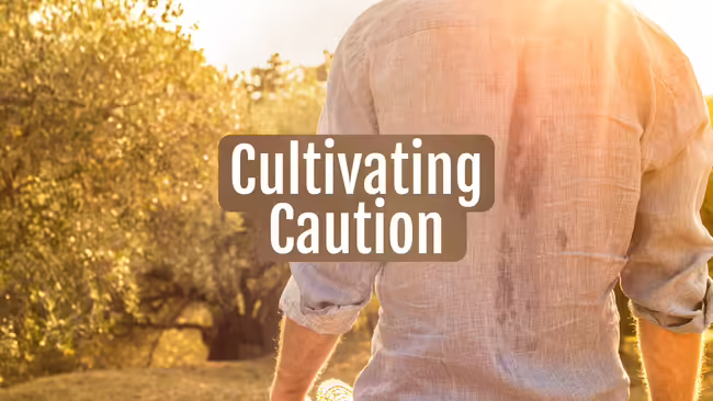 A person's back of their shirt sweating through while working outdoors in the hot sun.