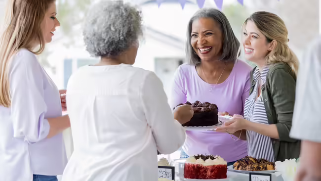 ladies serving cake at a fundraiser