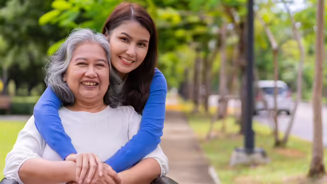 Daughter with her arms around her senior mother