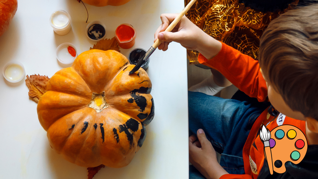 A child painting a pumpkin.