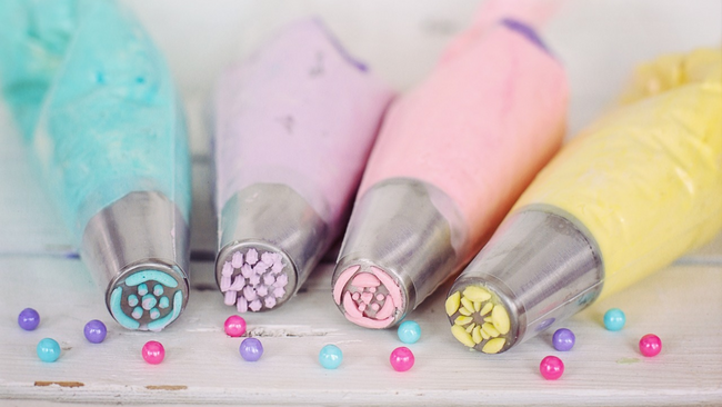 Cake piping bags filled with colorful icing