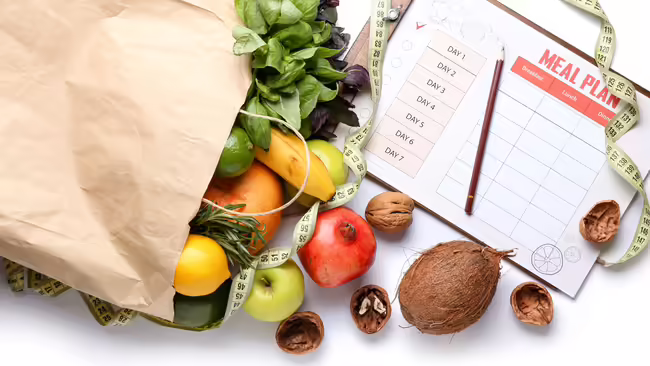 Meal planning, grocery bag spilling over with groceries pictured