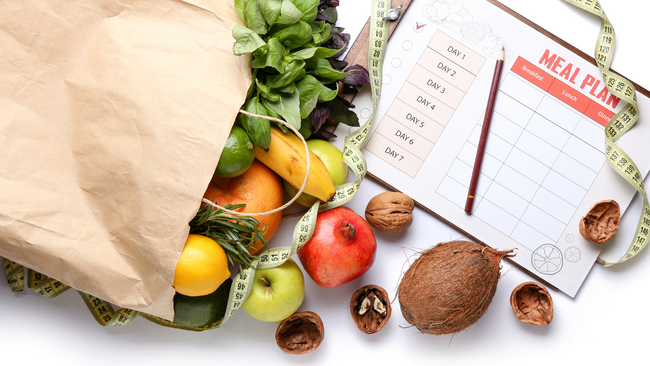 Meal planning, grocery bag spilling over with groceries pictured 