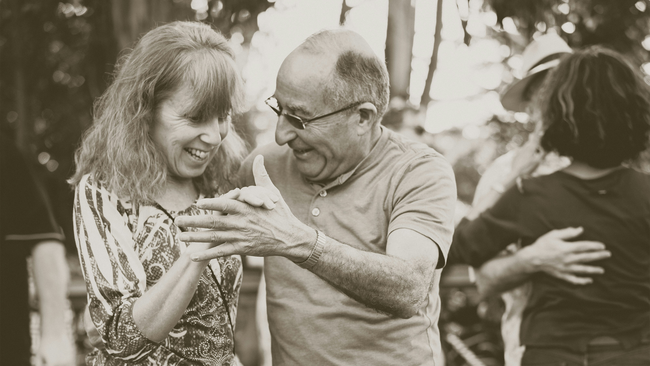 black and white photo of woman and man dancing