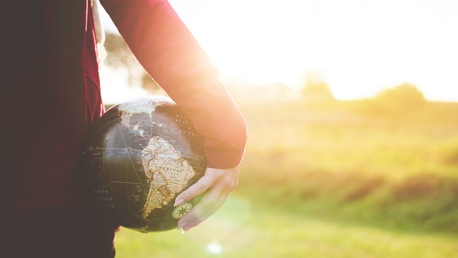 person holding a black globe