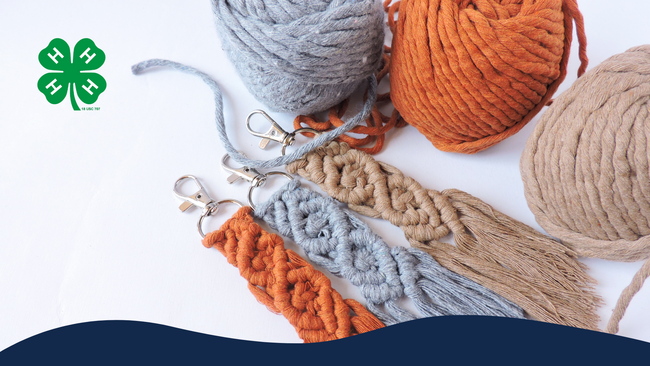 Orange, gray, and tan macramé key chains with balls of yarn next to the keychains.