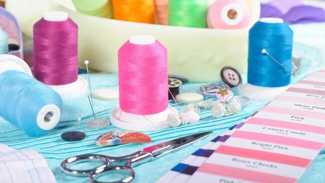 sewing materials like thread, scissors, needles, and buttons