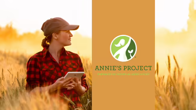 Graphic Woman with a ball cap wearing a red checkered shirt in a wheat field