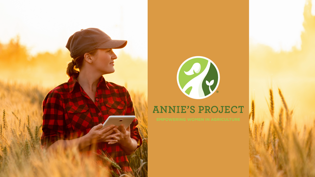 Graphic Woman with a ball cap wearing a red checkered shirt in a wheat field