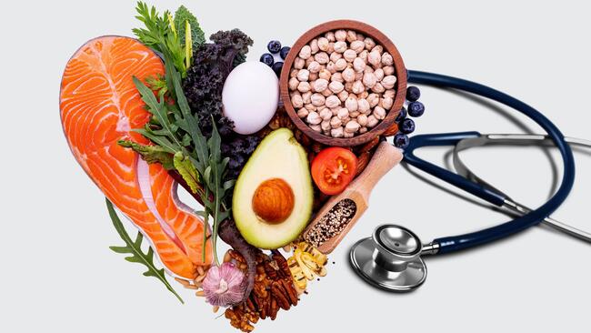 Healthy foods pictured in the shape of a heart with a stethoscope 