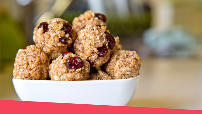 Rolled protein balls sitting in a white bowl.