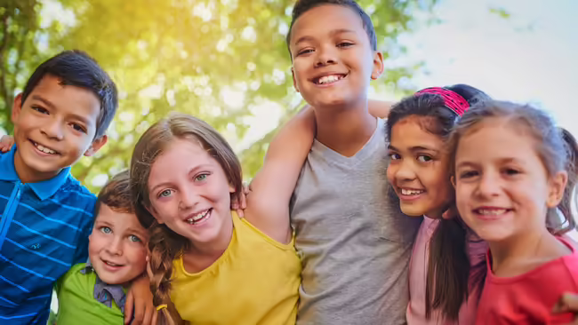 smiling kids with arms around each other