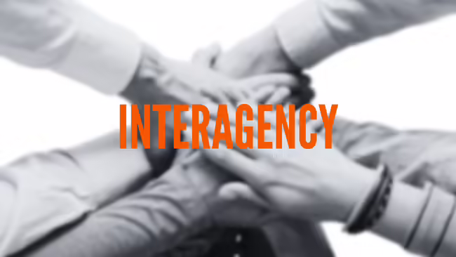 hands piled together with the word Interagency