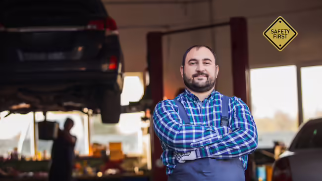 a mechanice standing in front of a car