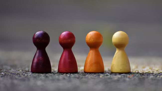 Chess pieces looks like people different colors