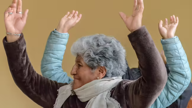 Older woman hands raised above head