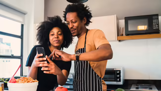 two people cooking together in a kitchen