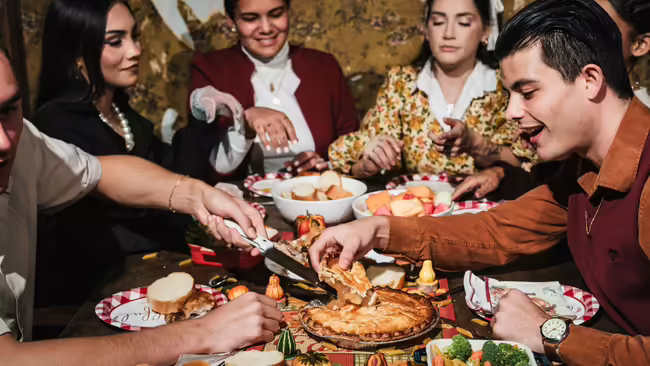 Group of friends eating at a table for a holiday