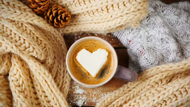cup of hot coco with a heart shaped marshmallow on top