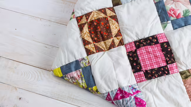 A quilt with different patterns of quilt squares