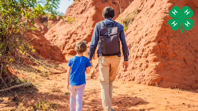 boy and adult walking in the desert