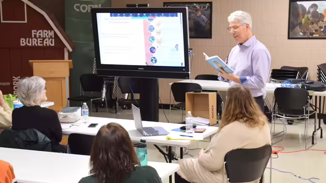 a man presenting in front of a screen