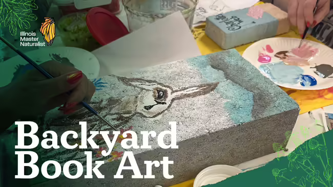 Person painting on large, gray stone.