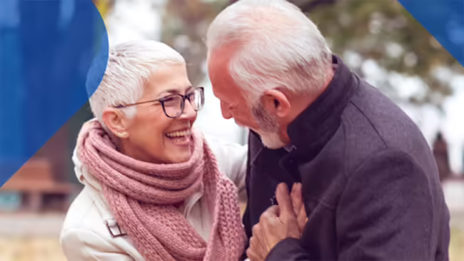 Older couple hugging and smiling